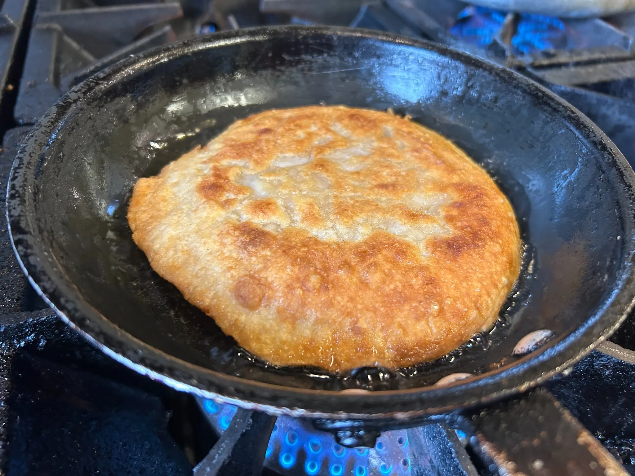 An XL potato-cheese pierogi being pan-fried as one of the buns for the Pierogi Smash Burger at Kat’s Café & Restaurant.