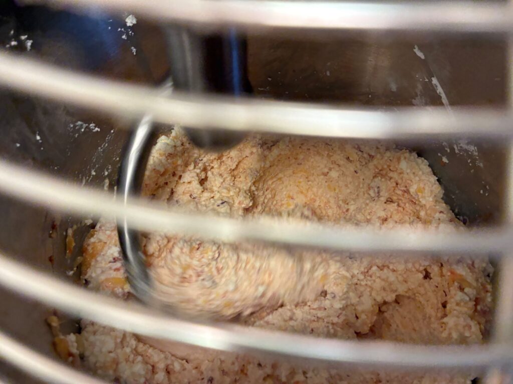 Perspective of Seeing Kat's Peach Sweet Cheese Pierogi Filling Being Mixed in the Mixer Through the Closed Grate.