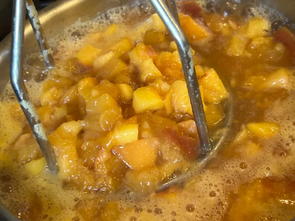 Fresh peach pieces being prepared in a pot at Kat’s Café & Restaurant for Kat’s peach pierogi filling.