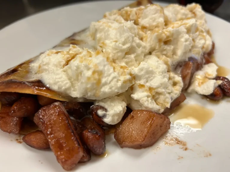 Crepe filled with caramelized pears, almonds, and topped with maple-infused whipped cream, and syrup at Kat’s Café & Restaurant.