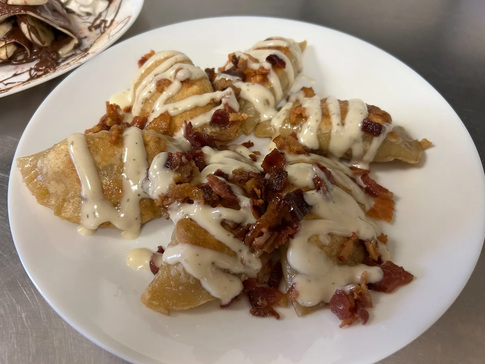 Bacon chicken ranch pierogies topped with crisp bacon and creamy ranch sauce at Kat’s Café & Restaurant.