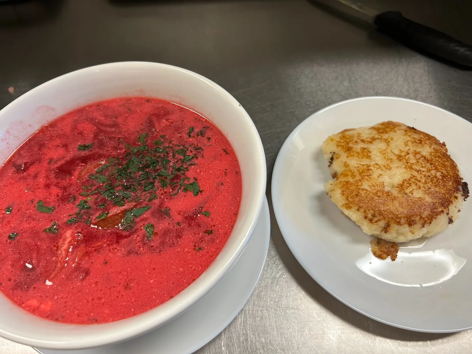 Creamy red beet borscht with kielbasa and chopped herbs, served with a pan-fried mashed potato cake at Kat’s Café & Restaurant.