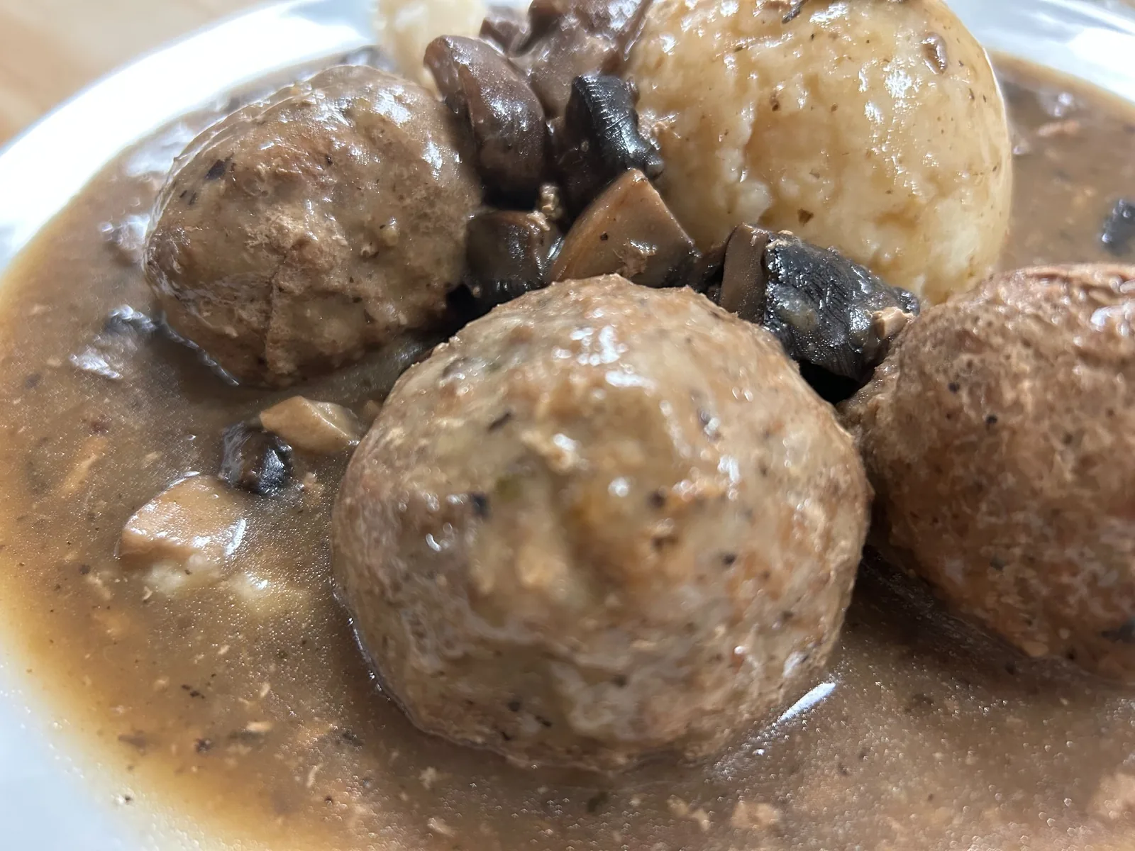 Close-up of homemade meatballs served with mushroom gravy, mushrooms, and mashed potatoes at Kat’s Café & Restaurant.