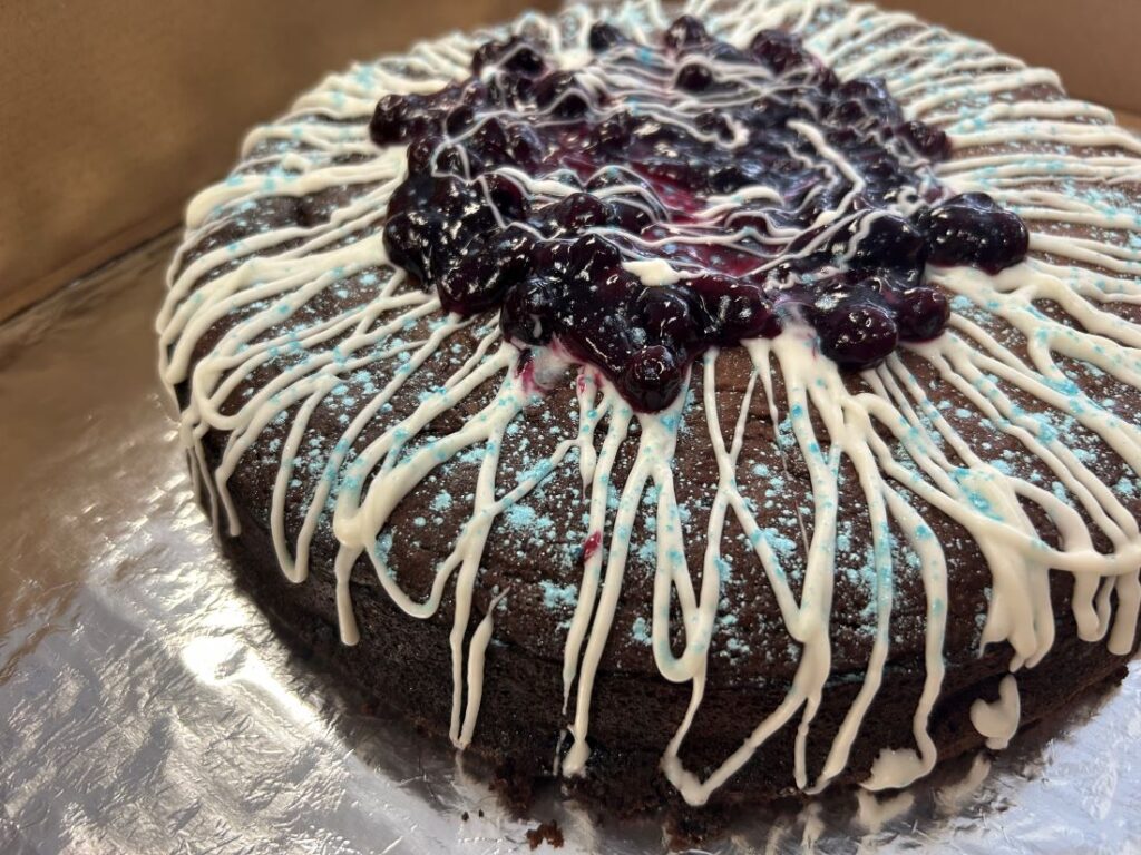 Blueberry Frosted Chocolate Lava Cake with Vanilla Swirls.