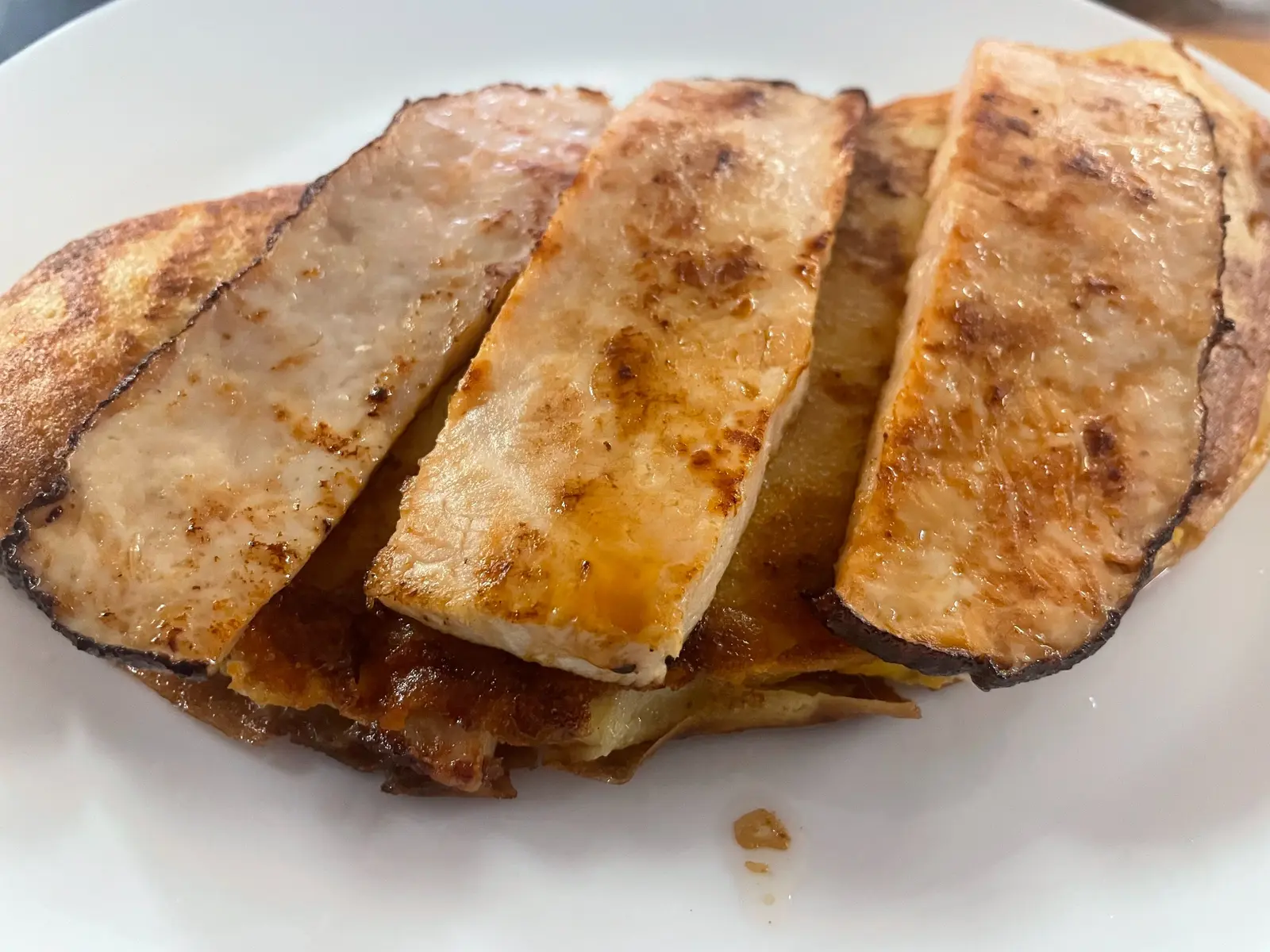 Pan seared turkey, egg and cheese breakfast crepe topped with thick slices of grilled turkey and served on a white plate at Kat’s Café & Restaurant. Of the three, I recommend: