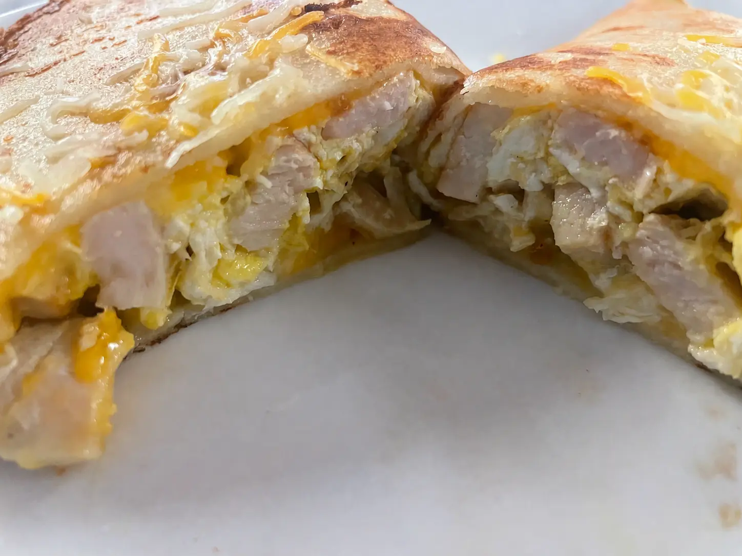 Cut turkey, egg and cheese breakfast crepe showing grilled turkey, scrambled eggs, and melted cheese inside a lightly browned Polish crepe at Kat’s Café & Restaurant.