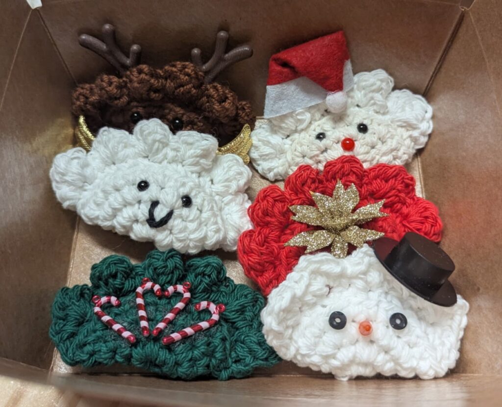 Kat's Adorable Christmas Tree Pierogi Product Decorations Box of 6 having Santa, Frosty, Reindeer, Candy Canes, and other crochet items.