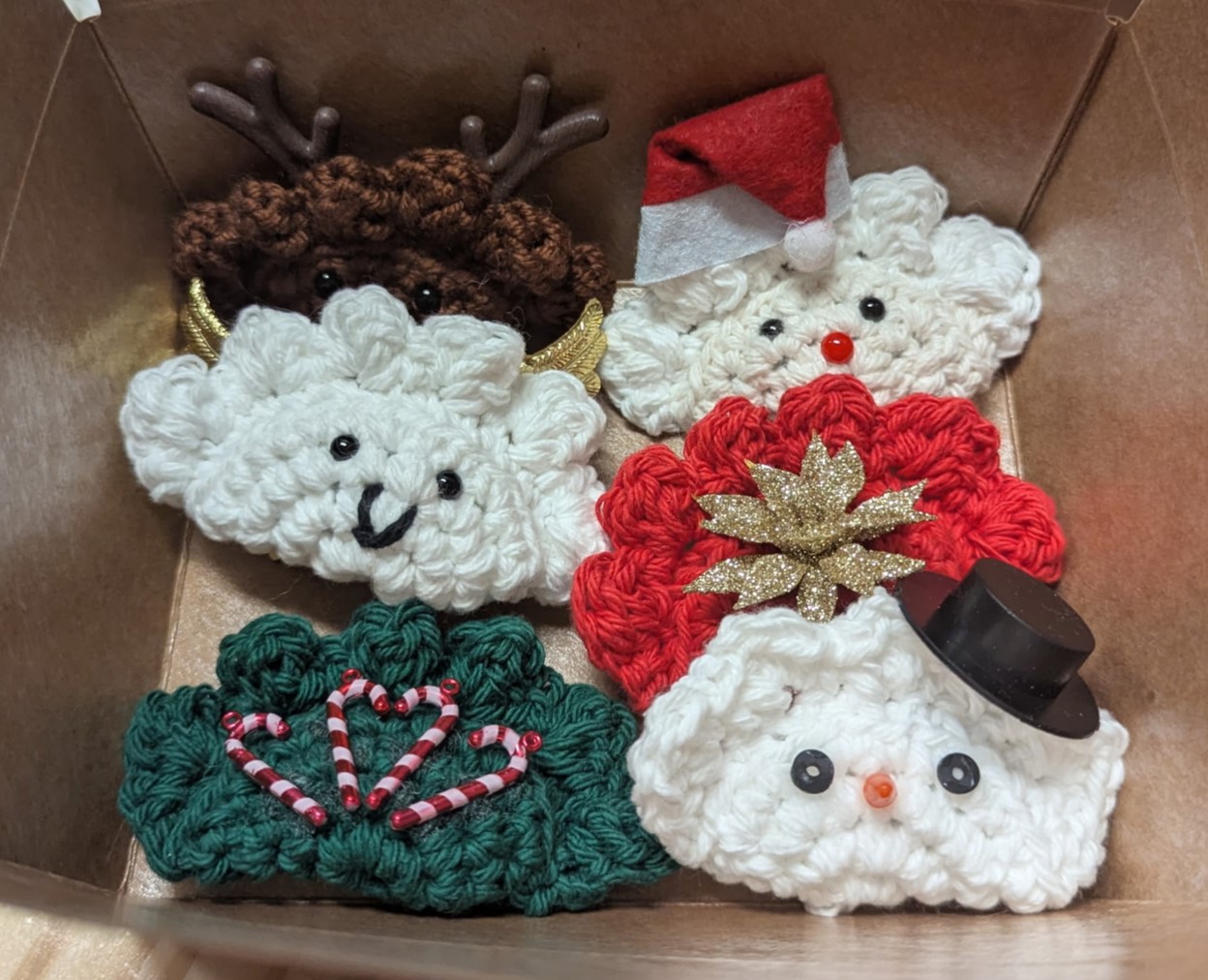 Kat's Adorable Christmas Tree Pierogi Product Decorations Box of 6 having Santa, Frosty, Reindeer, Candy Canes, and other crochet items.