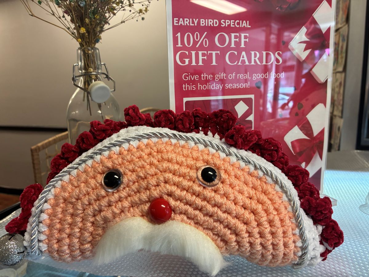 Early Bird Offer for Holiday Gift Cards with a Santa Clause Pierogi Pillow on Display by the Front Counter at the Restaurant.