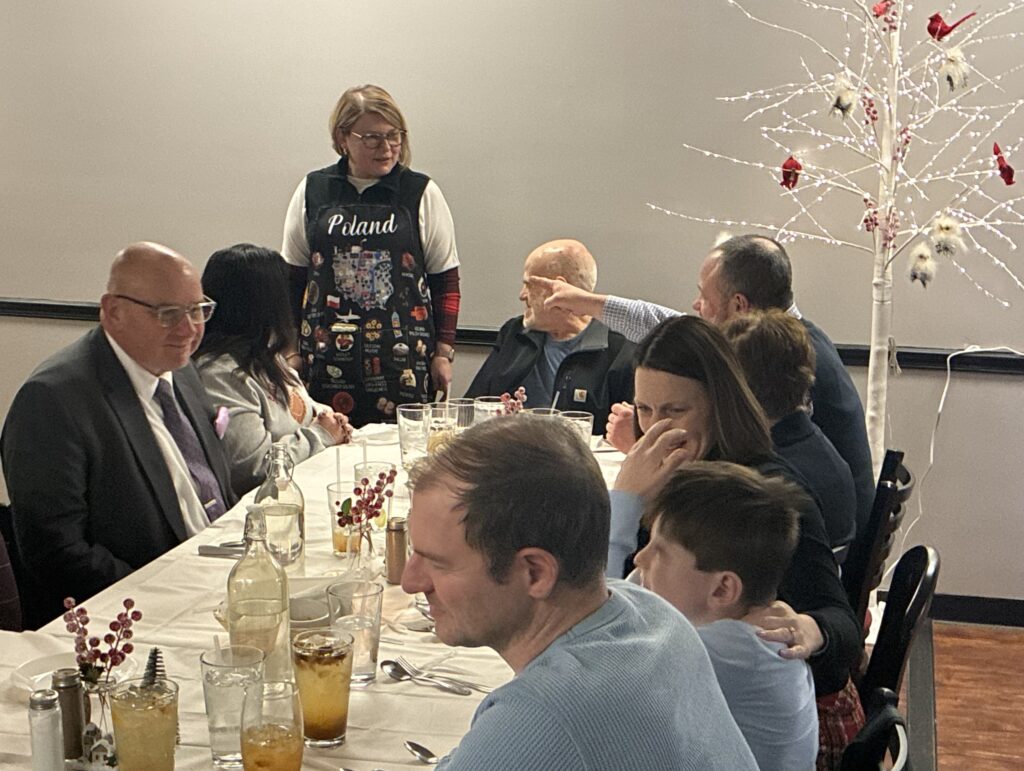 Kat's Wigili Pic of Chef Katherine Speaking to Happy Customers at the Holy Supper Event.