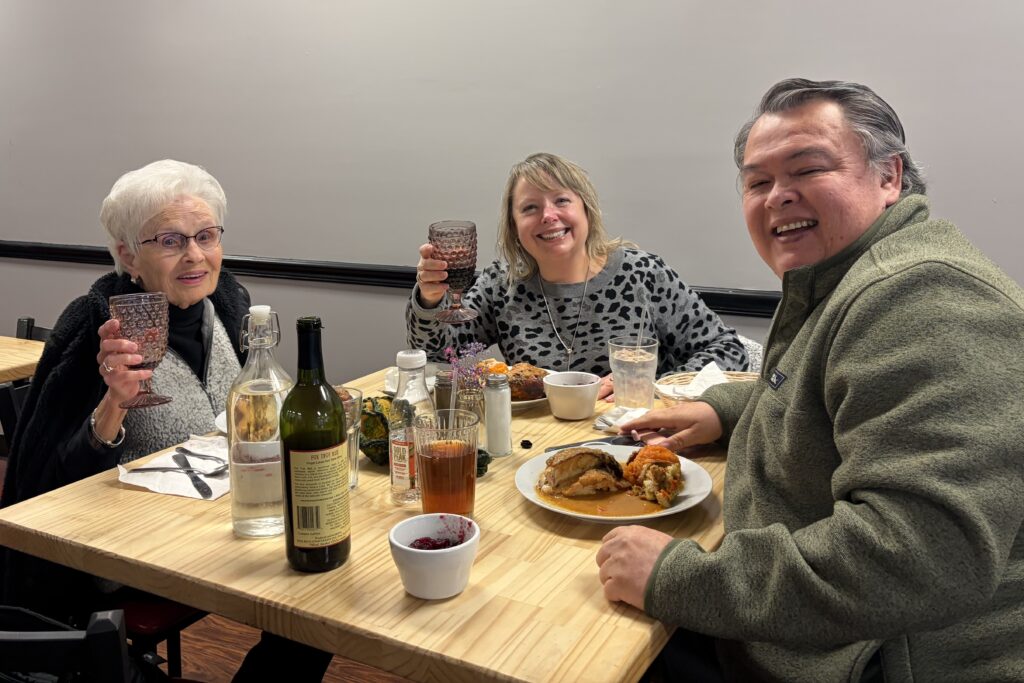 A photo of a trio of adults enjoying amazing food and wine at Kat's.