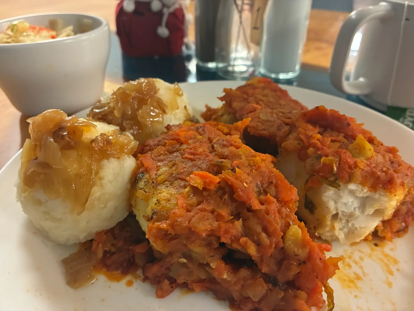 Polish Greek-style fish topped with tomato and vegetables, served with mashed potatoes and a side salad at Kat’s Café & Restaurant.