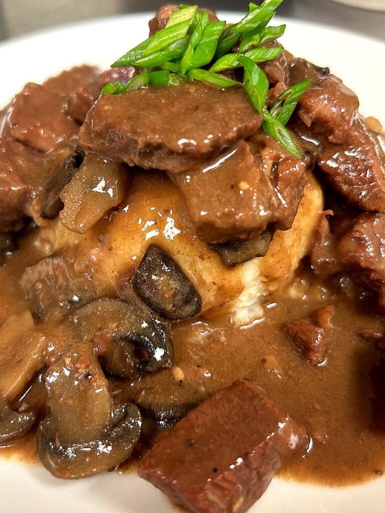 Beef and mushrooms in rich brown gravy served over potatoes, topped with green onions at Kat’s Café & Restaurant.