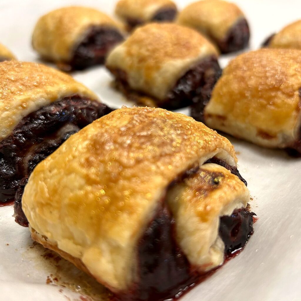 Fresh-baked croissant bites filled with cranberry marmalade, golden and flaky on a plate at Kat’s Café & Restaurant.
