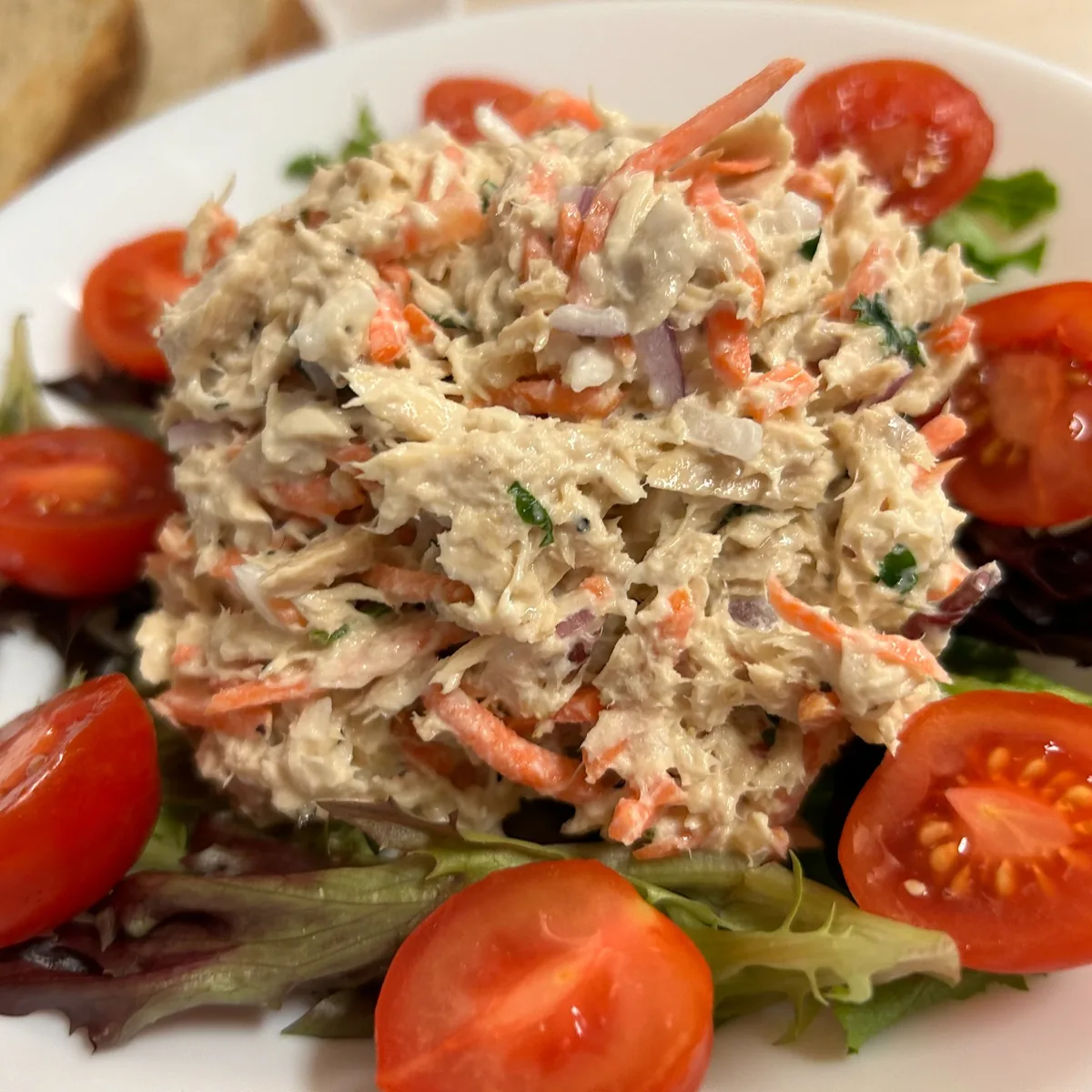 House tuna salad having lightly shaved vegetables, served on mixed greens with grape tomatoes.