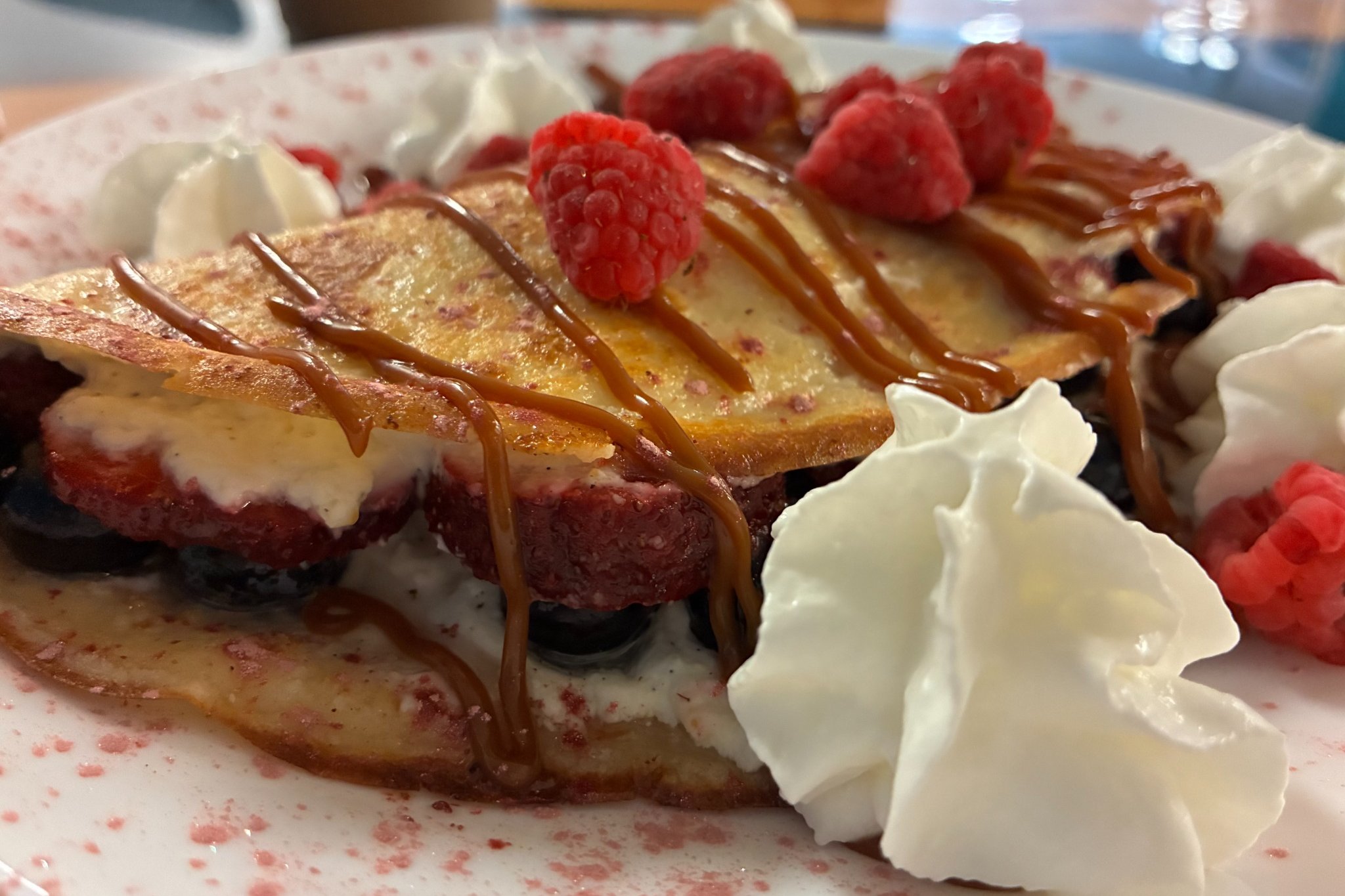 Sweet cheese crepe topped with fresh berries, whipped cream, and drizzle at Kat’s Café & Restaurant.