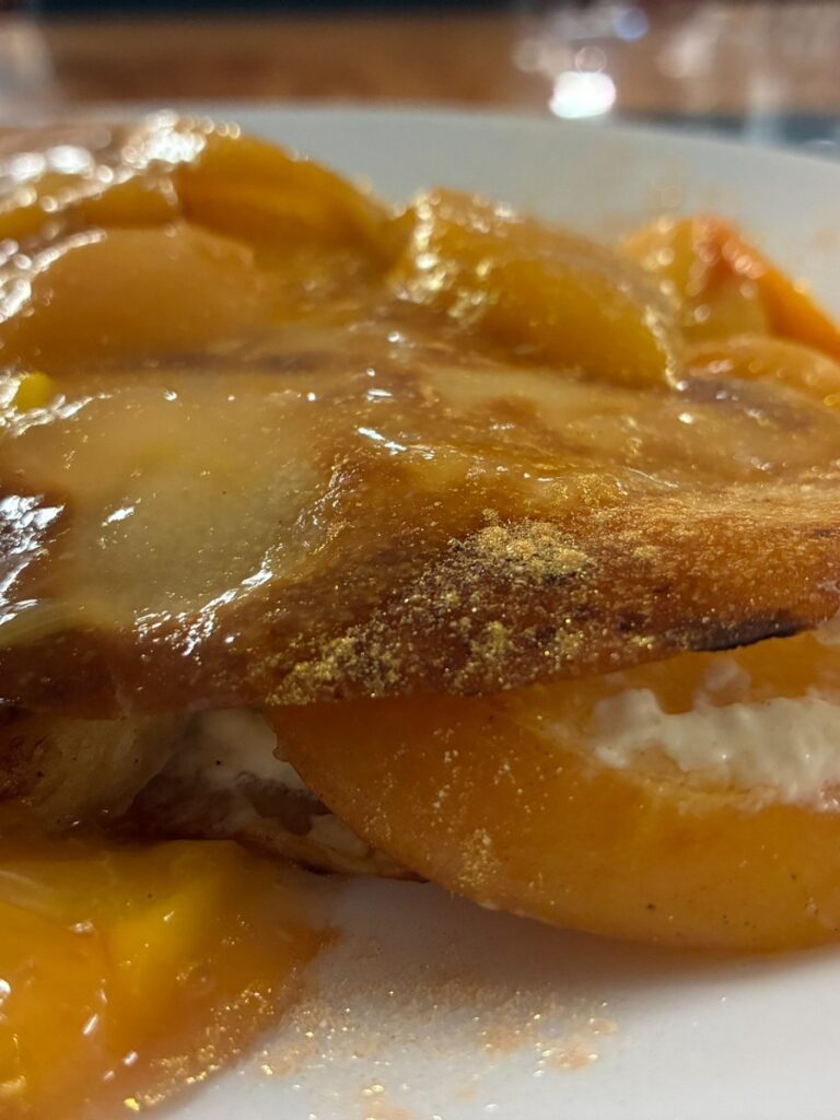 Peach and banana blintz served on a plate at Kat’s Café & Restaurant.