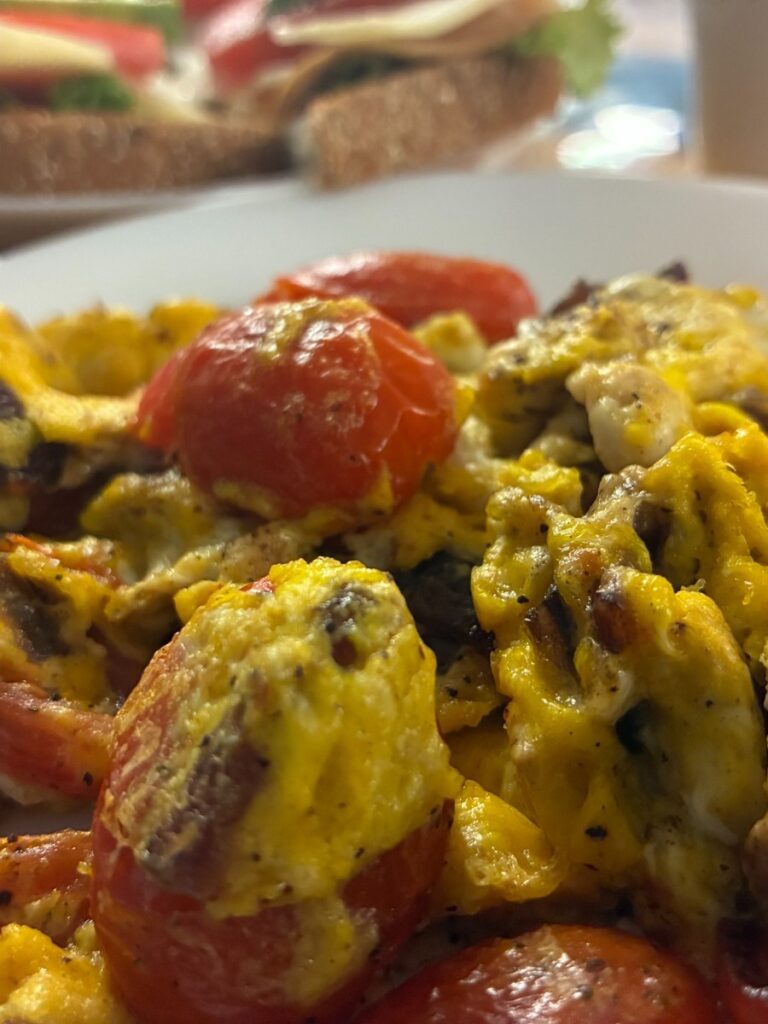 Scrambled eggs with cherry tomatoes on a plate at Kat’s Café & Restaurant.