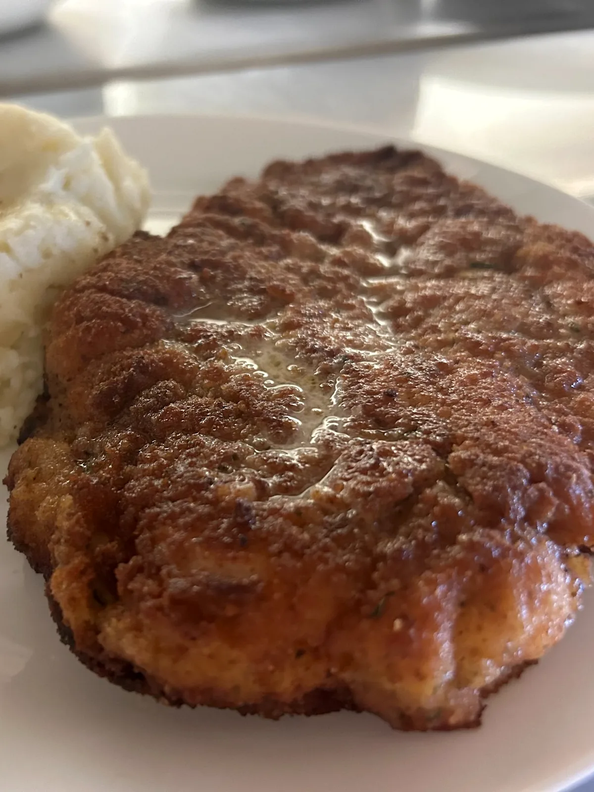 Breaded pork schnitzel cutlet served with mashed potatoes