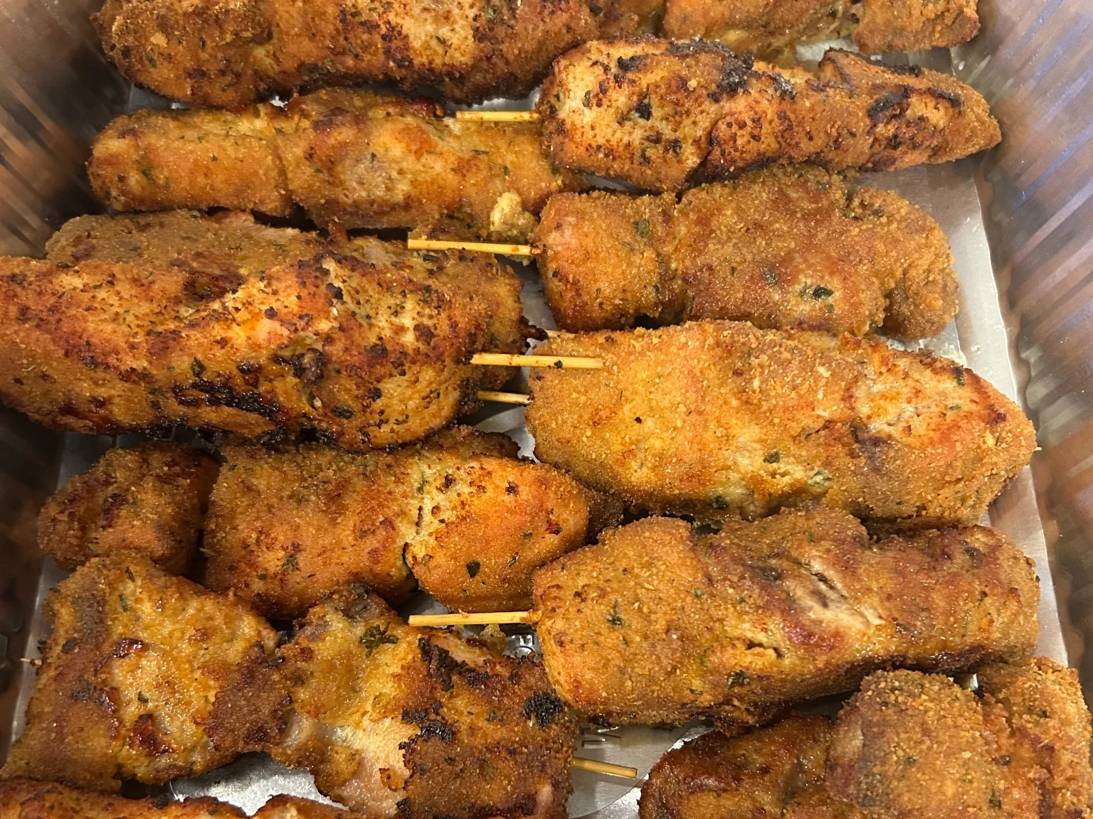 Golden breaded city chicken chunks on skewers arranged in a catering tray from Kat’s Café & Restaurant.