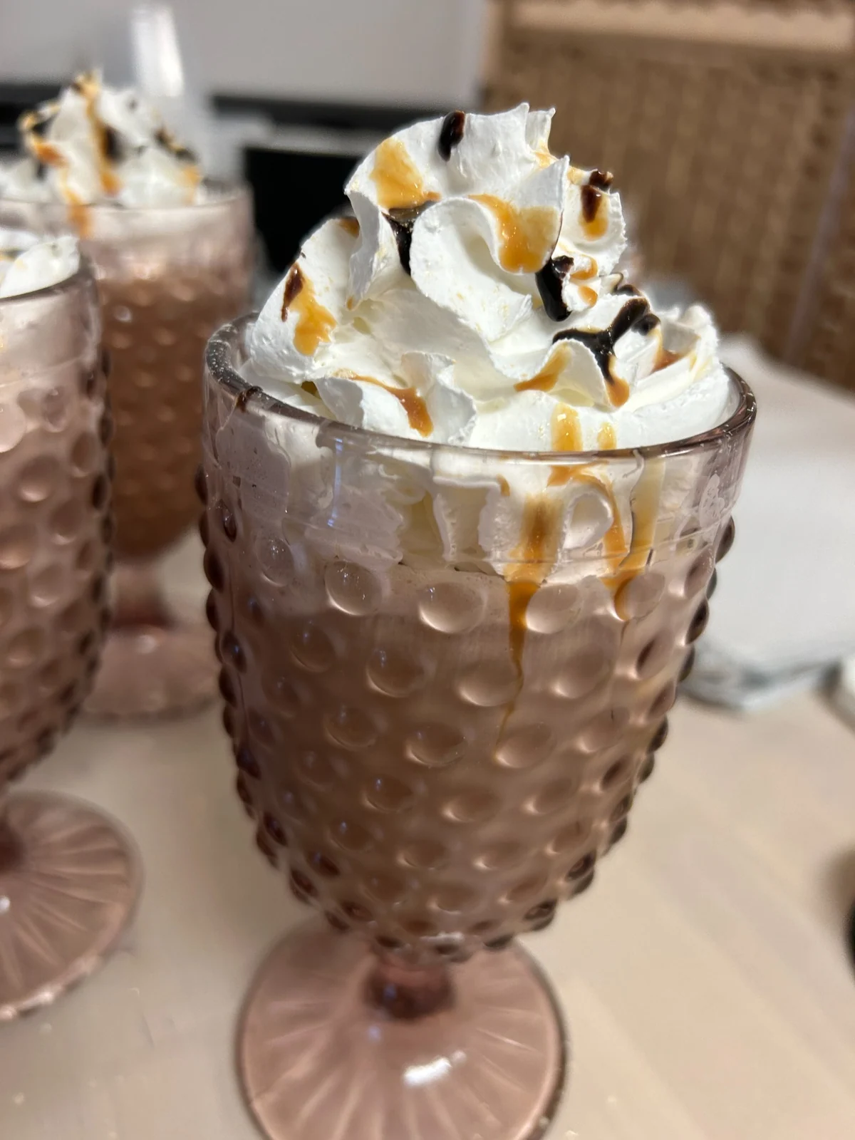 Coffee with ice cream topped with whipped cream, caramel, and chocolate drizzle at Kat's Café & Restaurant.