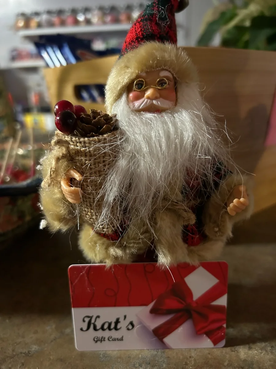 Santa holiday decoration displayed behind a Kat’s Café & Restaurant gift card.