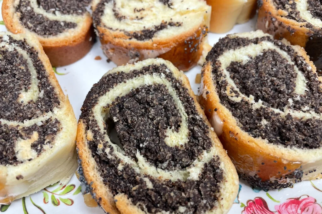 Sliced poppy seed strudels with swirled filling and a light glaze.