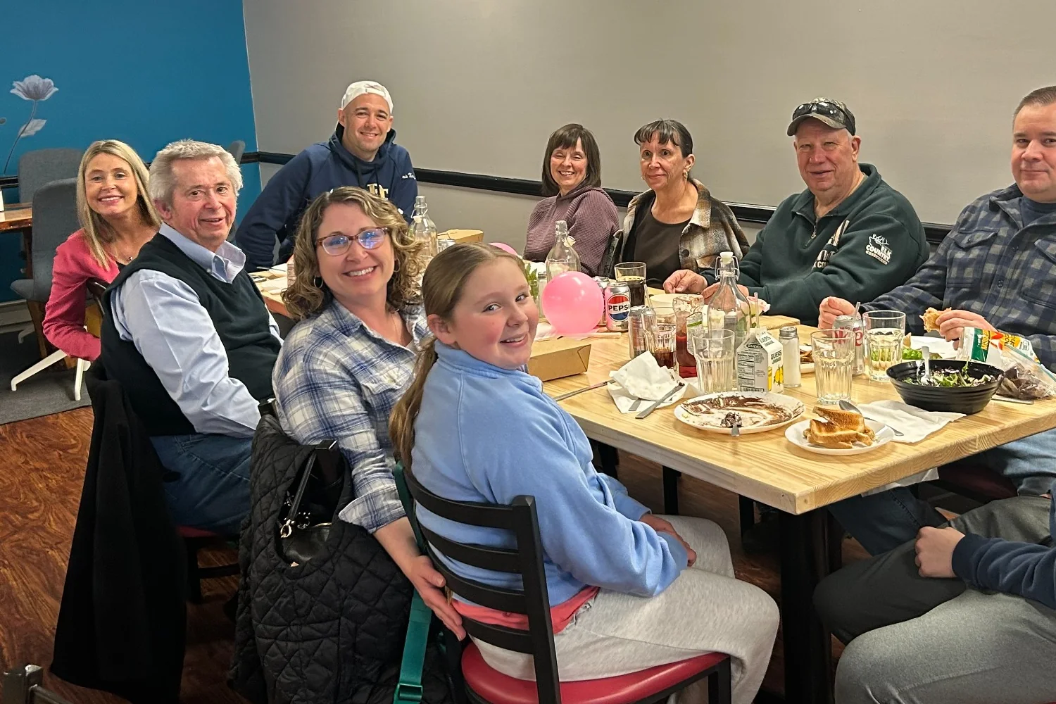 Guests seated around a shared table during a small private celebration at Kat's Café & Restaurant.