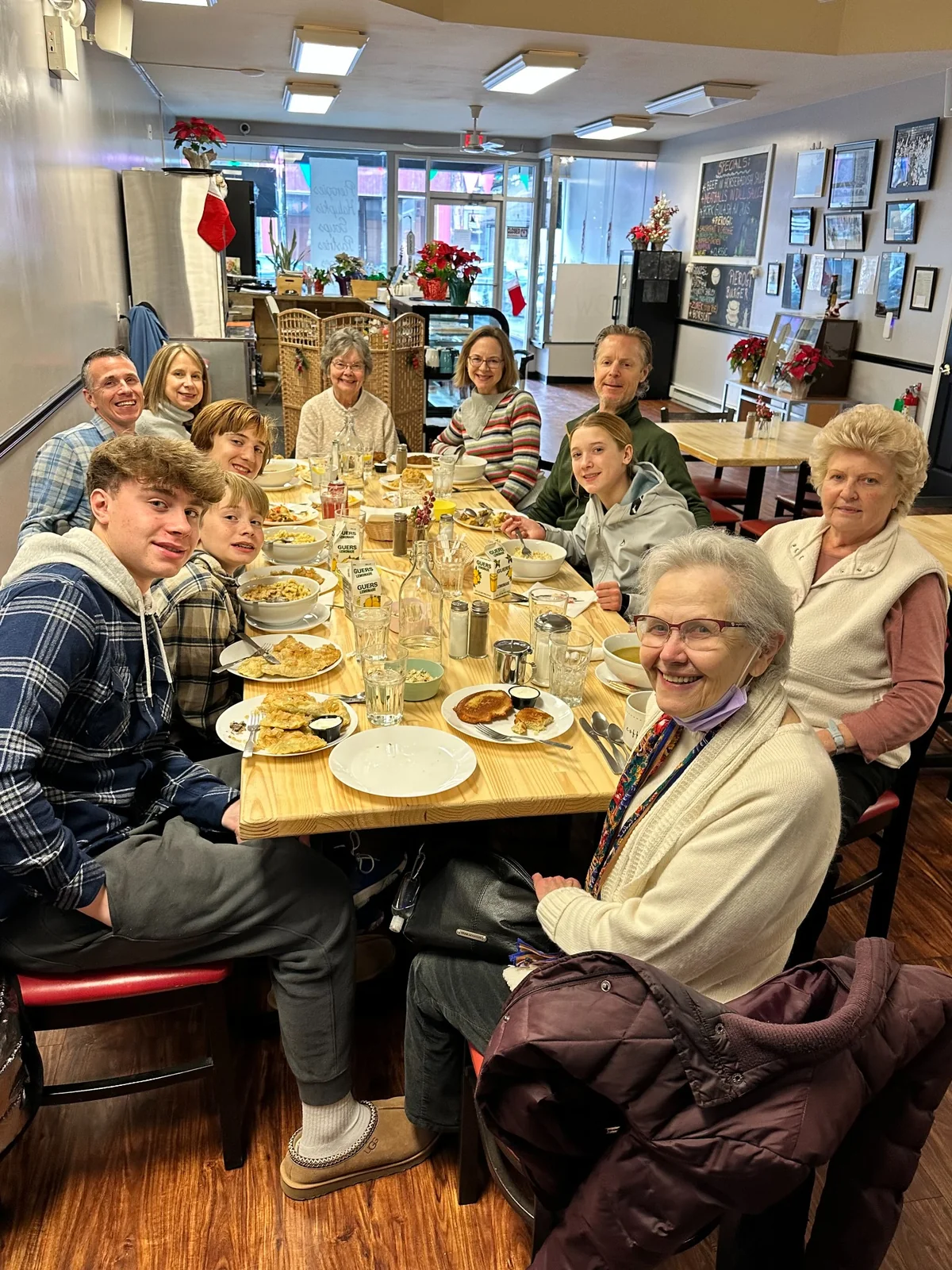 A multigenerational family gathering sharing a meal at Kat's Café & Restaurant.