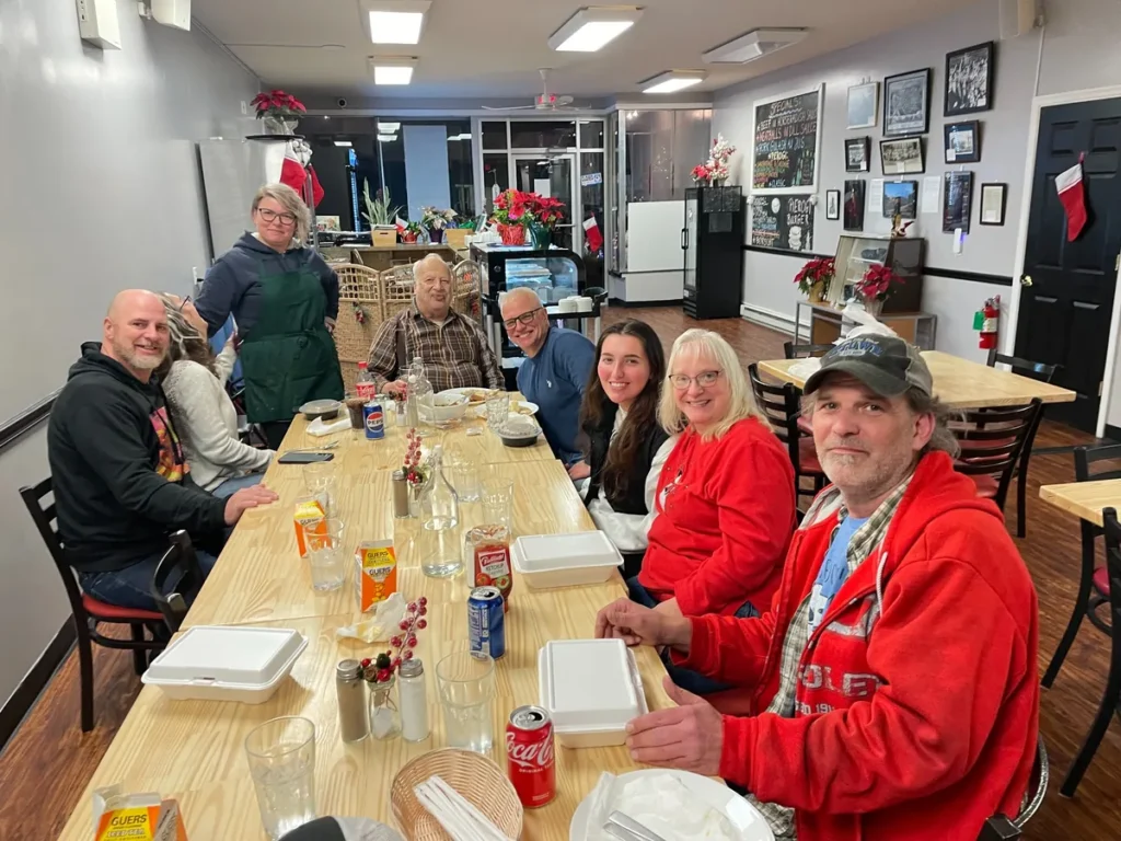 Guests seated around a long table for a group meal at Kat’s Café & Restaurant.