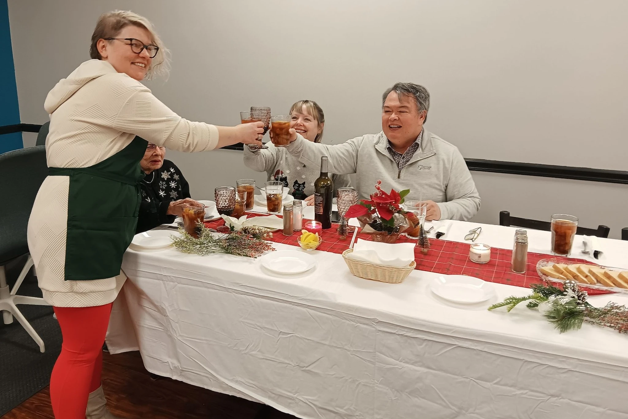 Chef Kat shares a toast with guests across the table during a Polish Holy Supper at Kat’s Café & Restaurant.