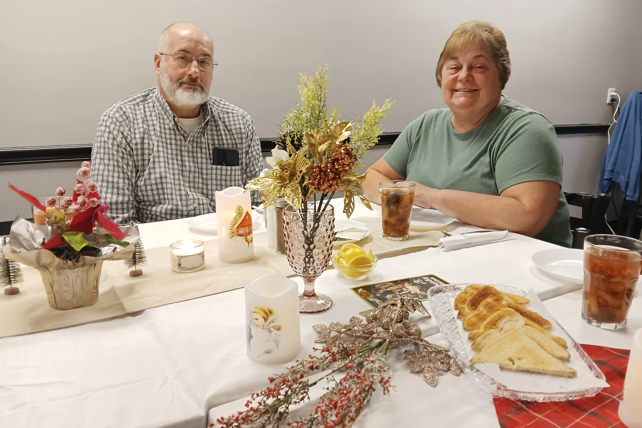 A couple seated at a decorated table during the Christmas Eve Holy Supper at Kat’s Café & Restaurant.