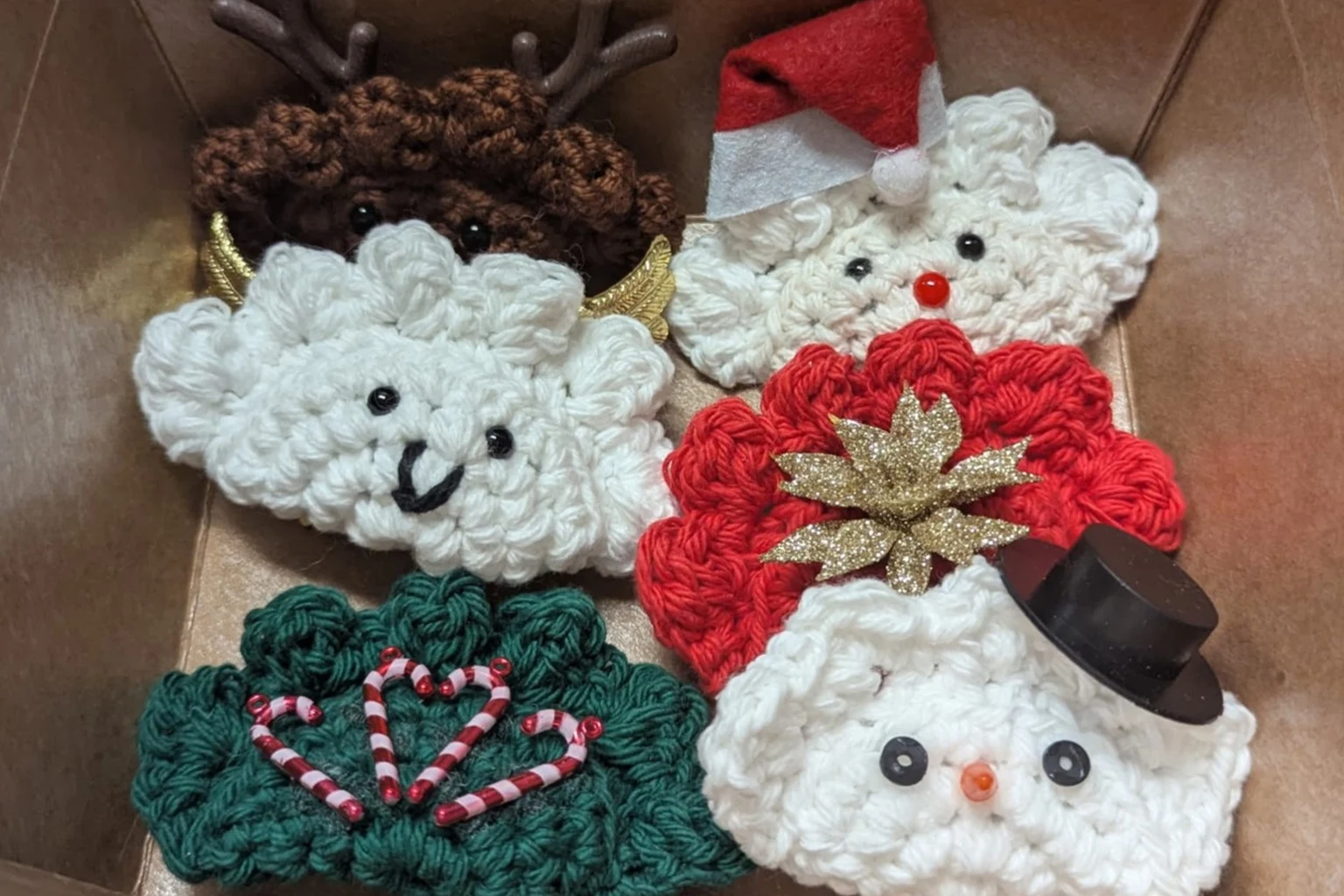 Boxed crochet ornaments assortment at Kat’s Gift box filled with assorted handmade crochet ornaments including holiday characters and decorations at Kat’s Café & Restaurant.
