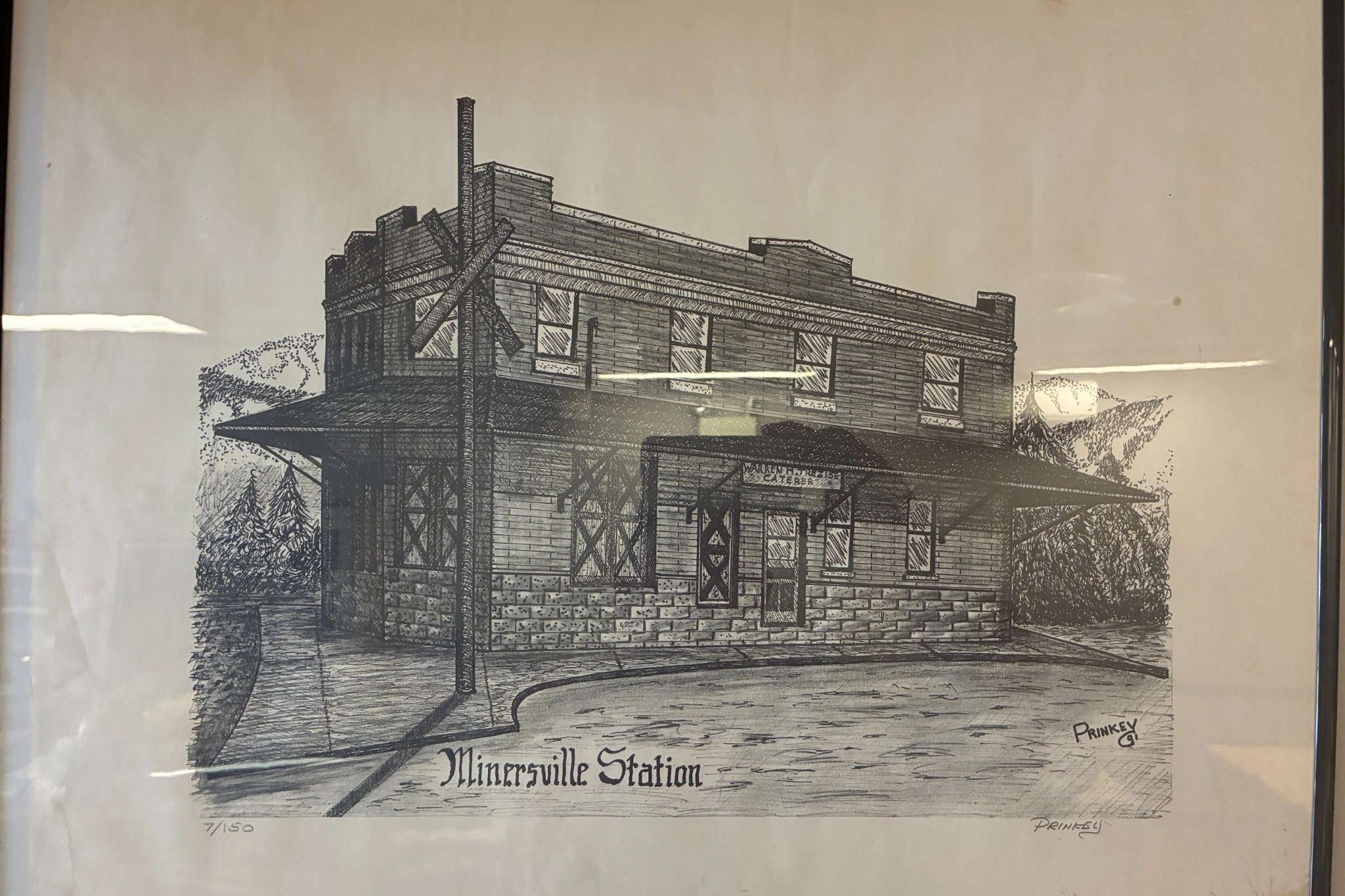 Framed black-and-white print of Minersville Station on display at Kat’s Café & Restaurant.