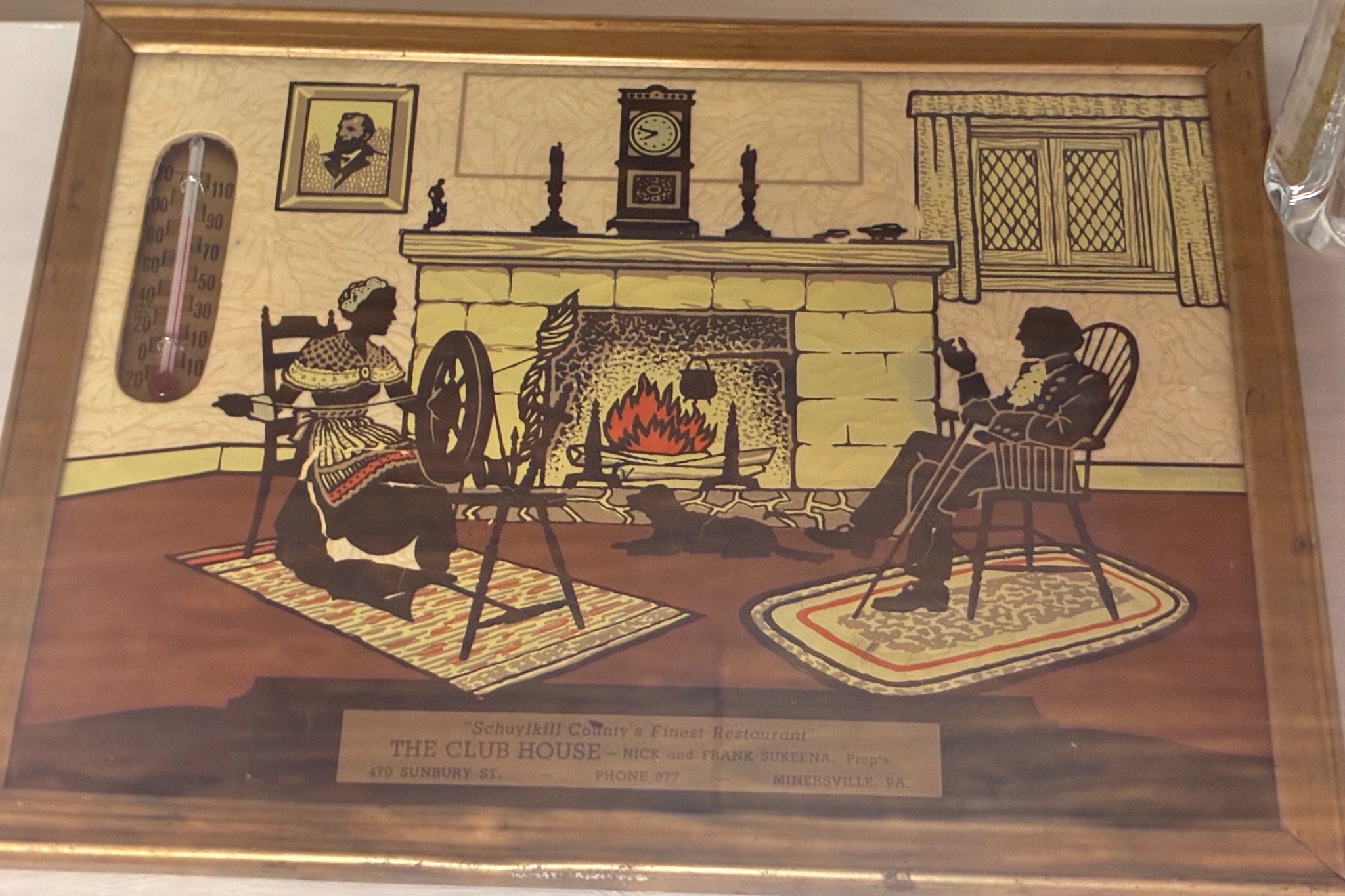 Framed vintage artwork for "The Club House" restaurant on display at Kat’s Café & Restaurant.