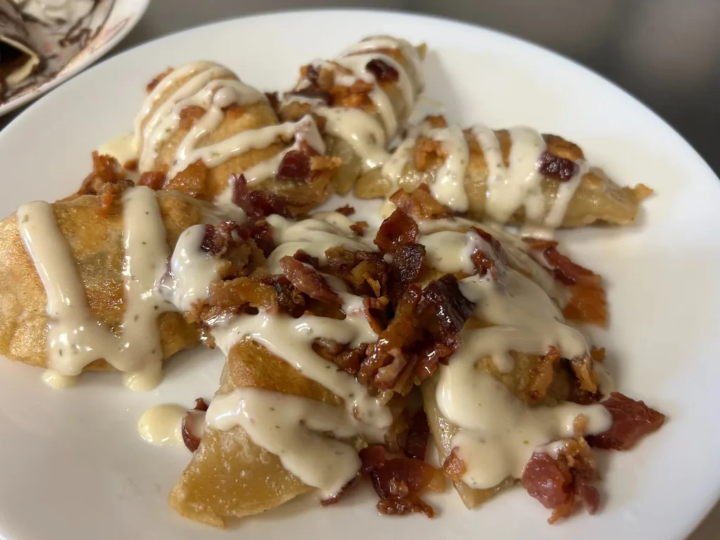 Pan-fried bacon chicken ranch pierogies topped with crumbled bacon and ranch sauce at Kat’s Café & Restaurant.