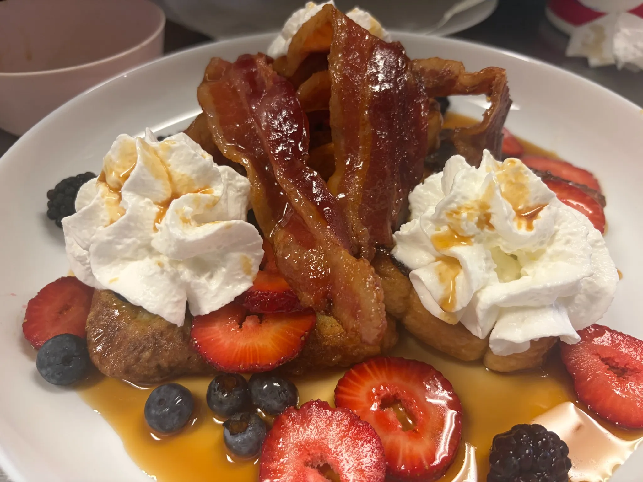 French toast topped with maple bacon, whipped cream, strawberries, blueberries, blackberries, and real PA maple syrup served at Kat’s Café & Restaurant.