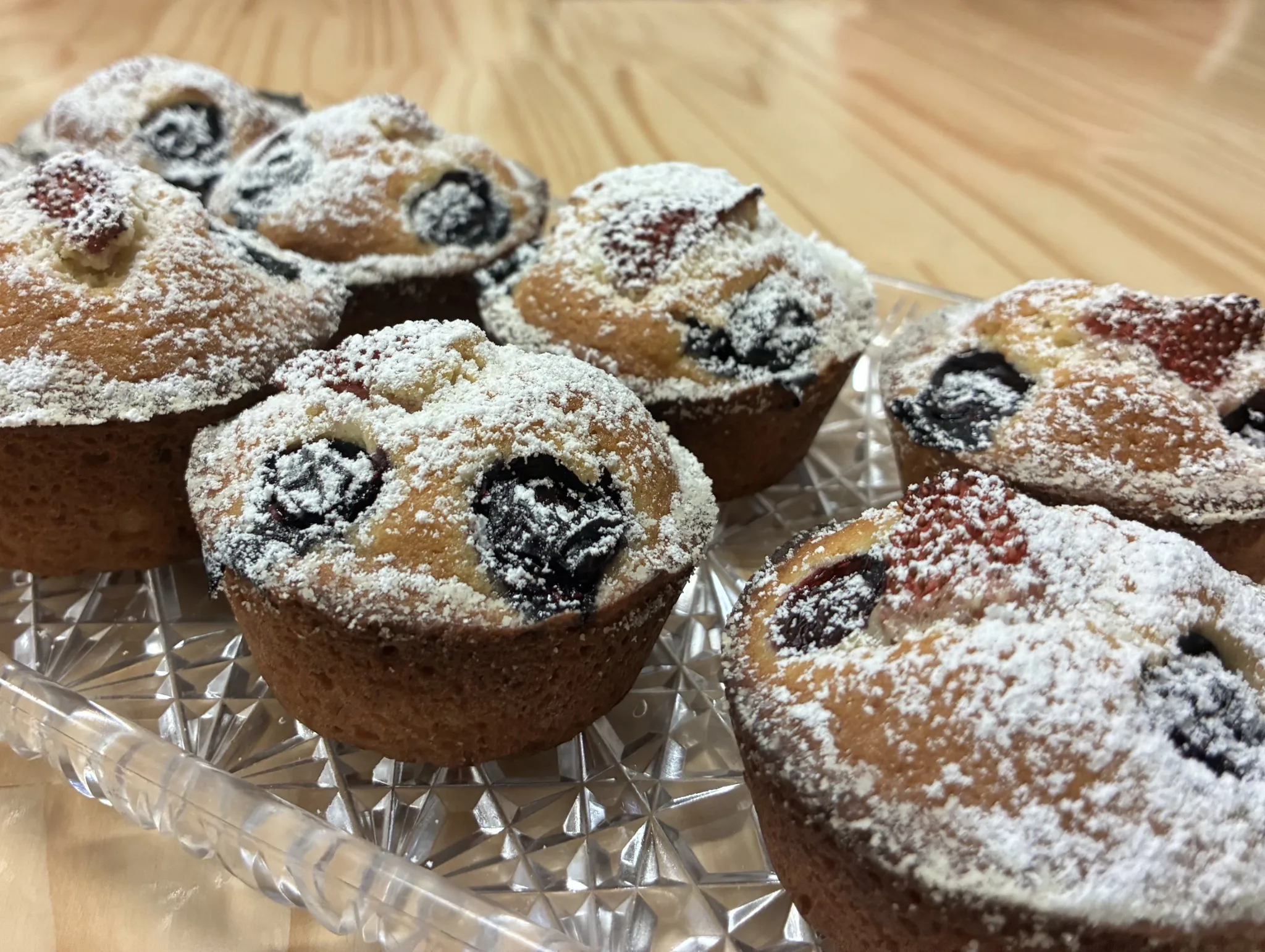 Mini berry cakes dusted with powdered sugar on a crystal tray at Kat’s Café & Restaurant.