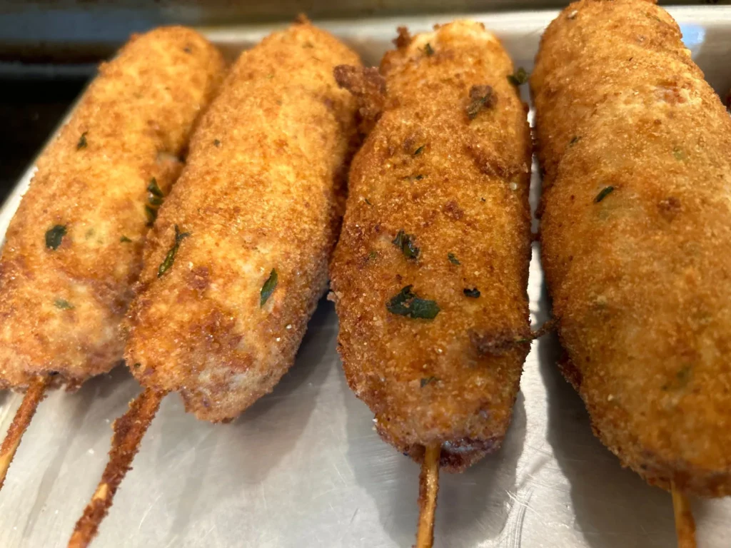 Close-up of several golden breaded city chicken skewers with a crisp fried coating at Kat’s Café & Restaurant.