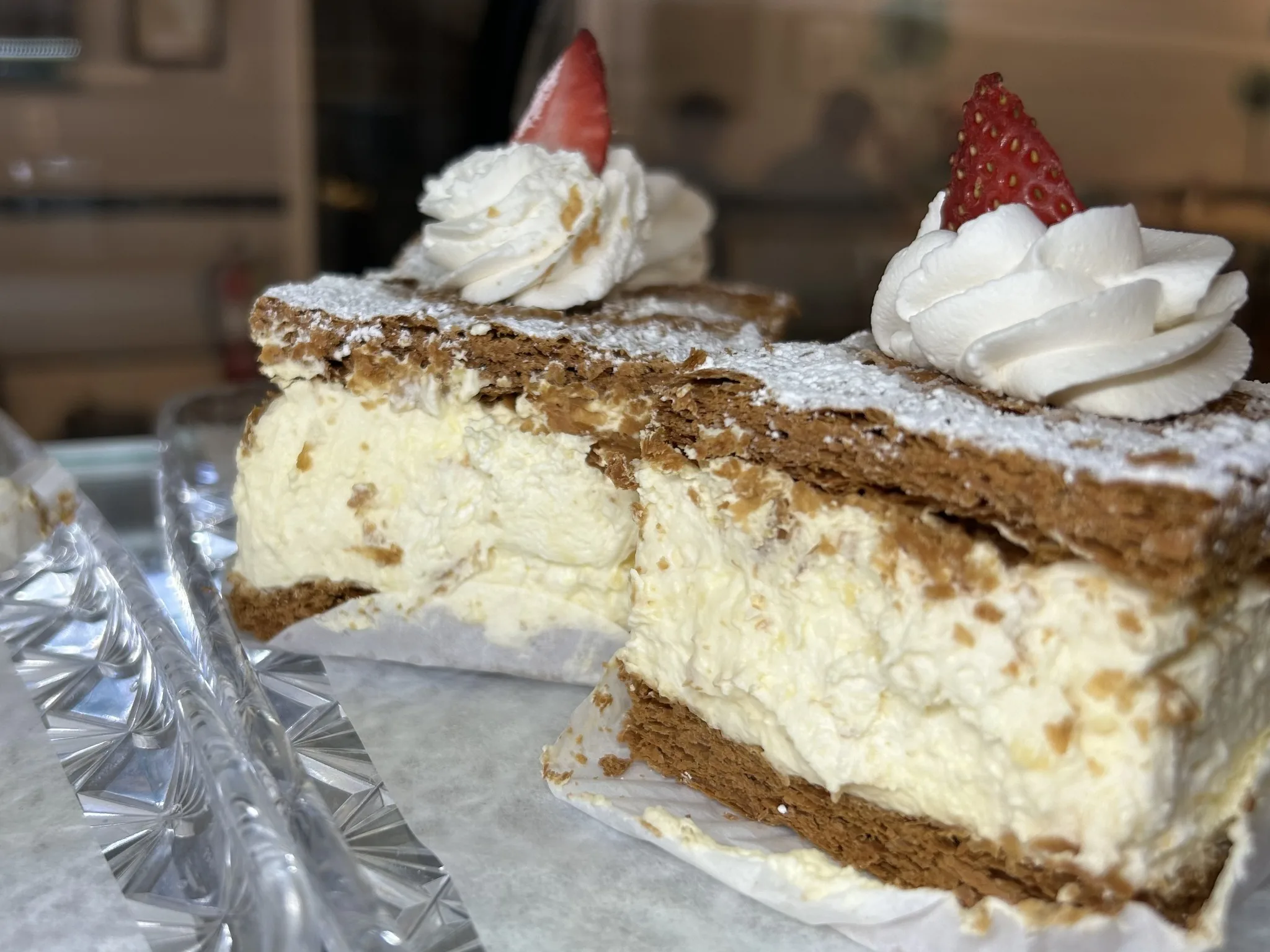 Cream-filled layered pastries topped with whipped cream and strawberries at Kat’s Café & Restaurant.