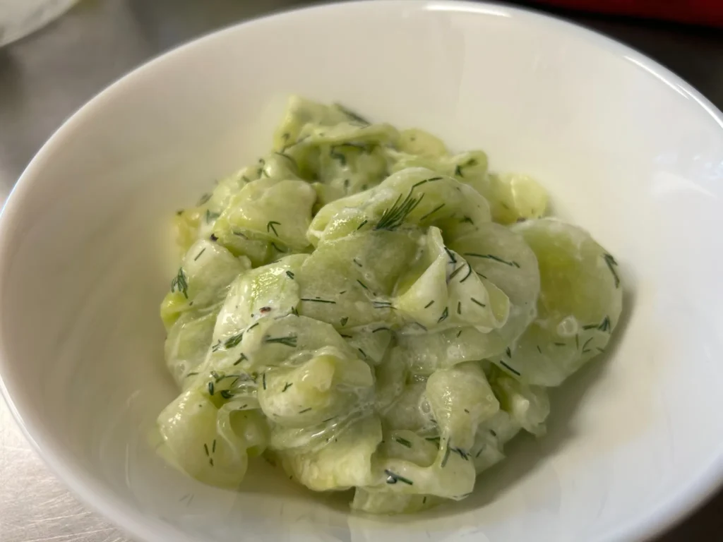 Bowl of cucumber dill salad in a creamy dressing at Kat’s Café & Restaurant.