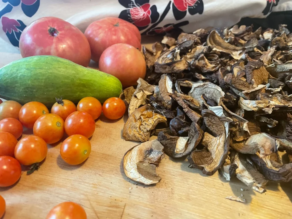 Fresh produce and dried mushrooms arranged on a cutting board in the kitchen at Kat’s Café & Restaurant.