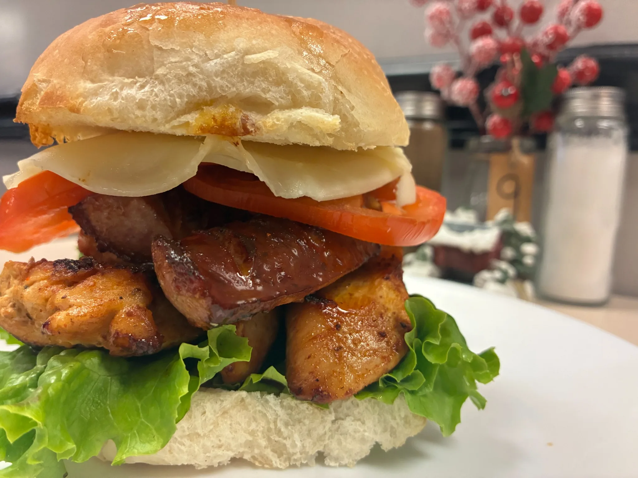 Grilled chicken and sliced kielbasa sandwich with cheese, tomato, and lettuce on a fresh bakery roll at Kat’s Café & Restaurant.
