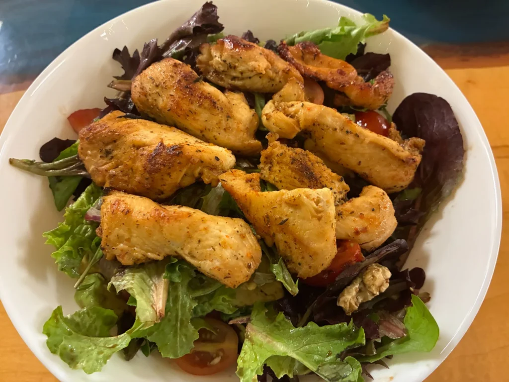 Mixed green salad topped with grilled chicken and tomatoes at Kat’s Café & Restaurant.