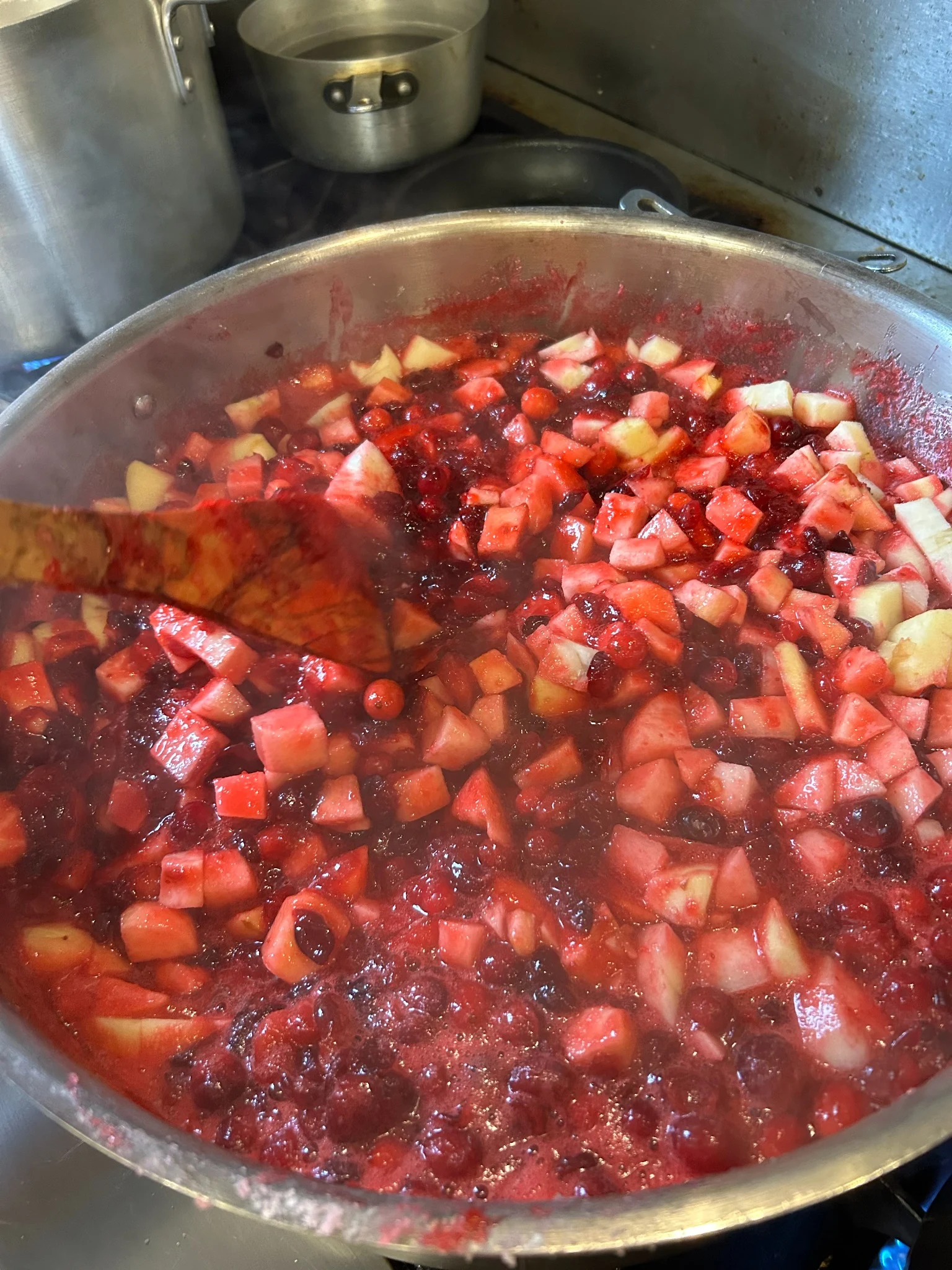 Homemade cranberry sauce with diced fruit simmering in a big pot at Kat’s Café & Restaurant.