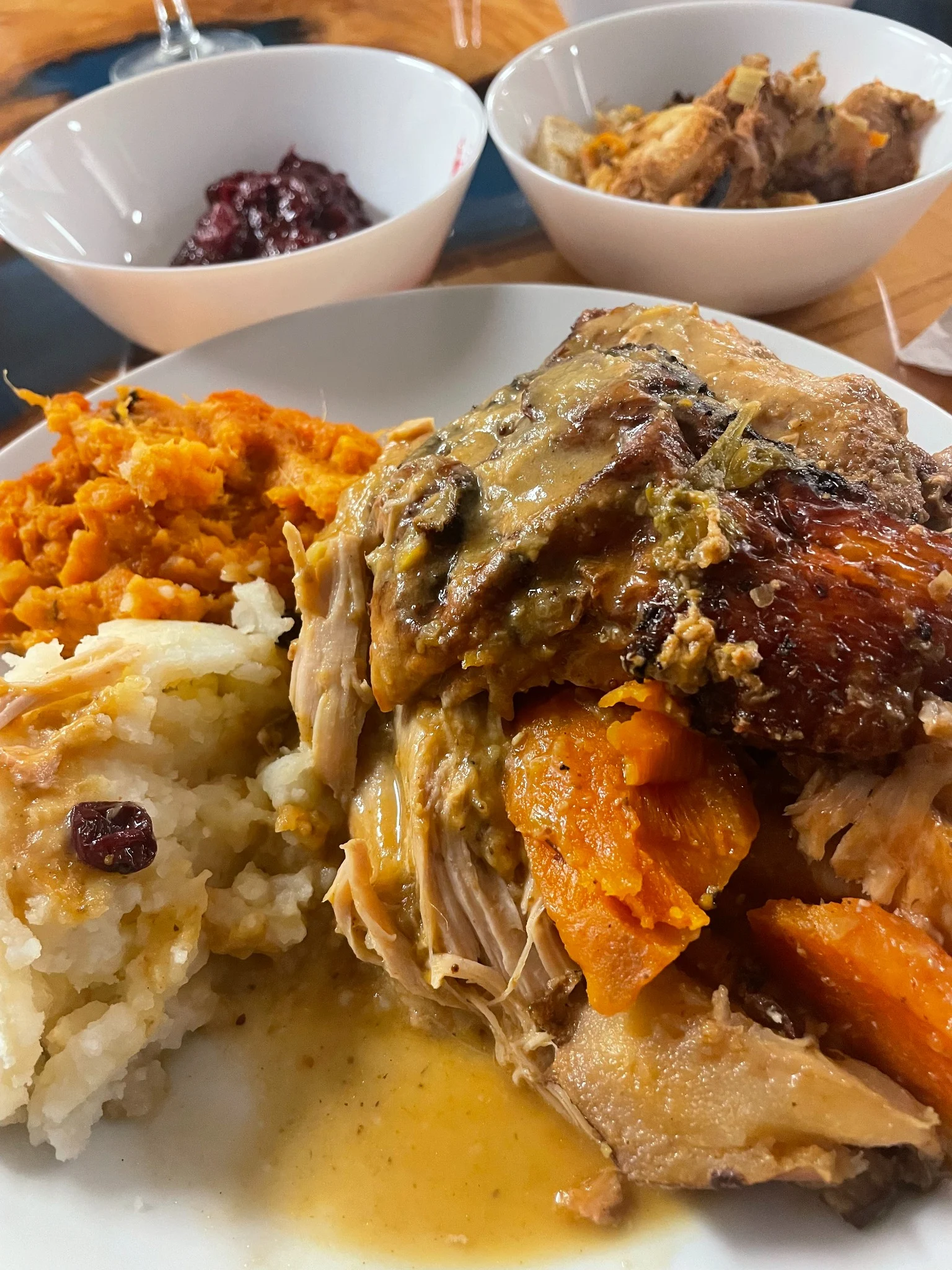 Homemade Thanksgiving dinner plate at Kat’s Café & Restaurant with roast turkey, gravy, mashed potatoes, sweet potatoes, yams, stuffing, and cranberry sauce.