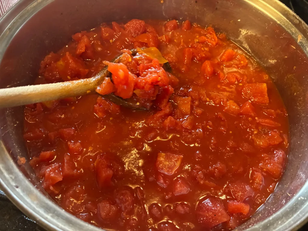 Chunky homemade tomato sauce simmering in a large pot in the kitchen at Kat’s Café & Restaurant.