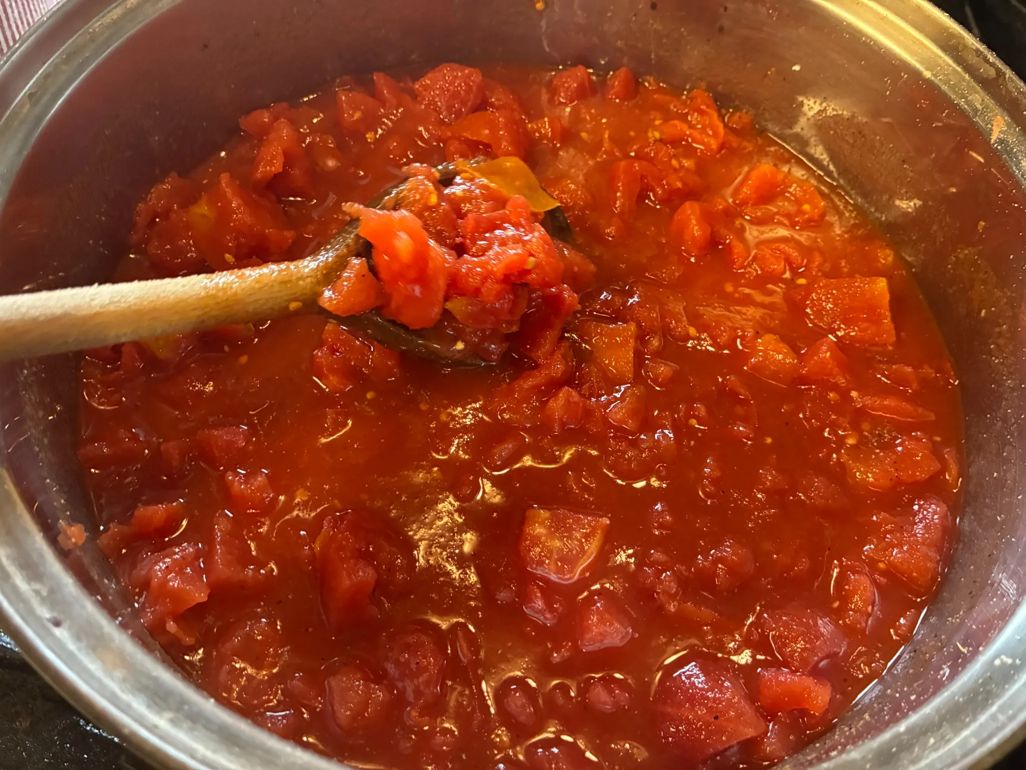 Chunky homemade tomato sauce simmering in a large pot in the kitchen at Kat’s Café & Restaurant.