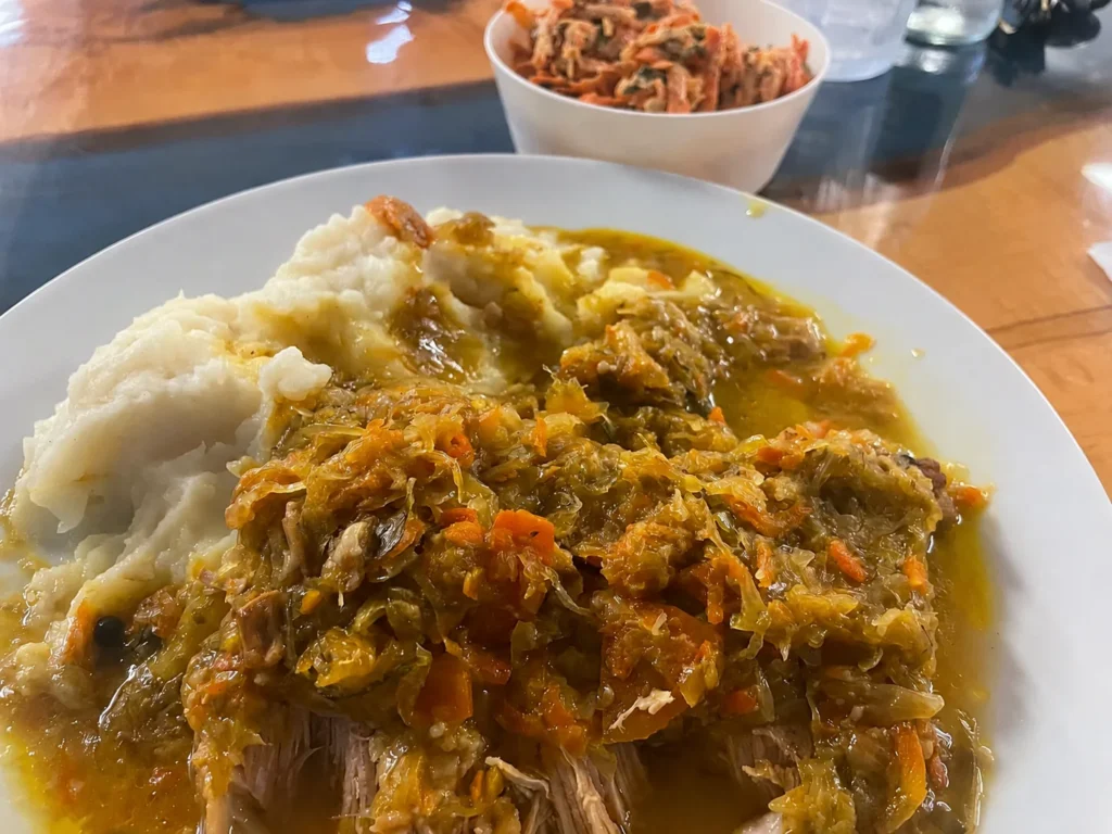 Homestyle pork and sauerkraut served with mashed potatoes and a shredded vegetable side at Kat’s Café & Restaurant.