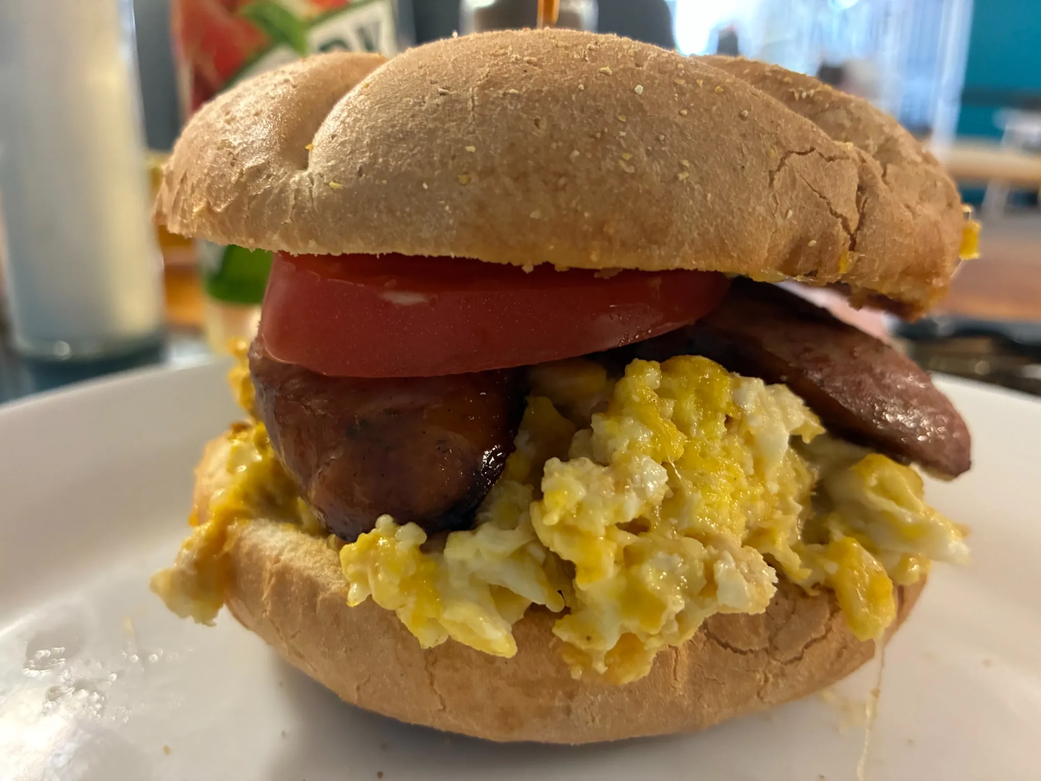 Breakfast sandwich on a roll filled with scrambled eggs, kielbasa, and tomato served at Kat’s Café & Restaurant.